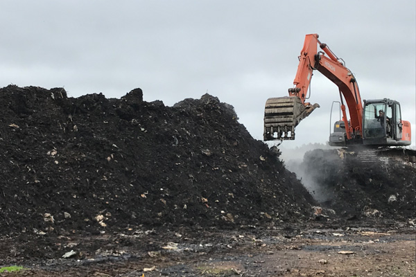 Winrow composting process - digger turning the compost in Truro, Nova Scotia